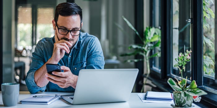 Man reviewing credit monitoring dashboard on a laptop