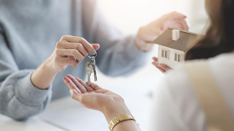 Person handing over house keys