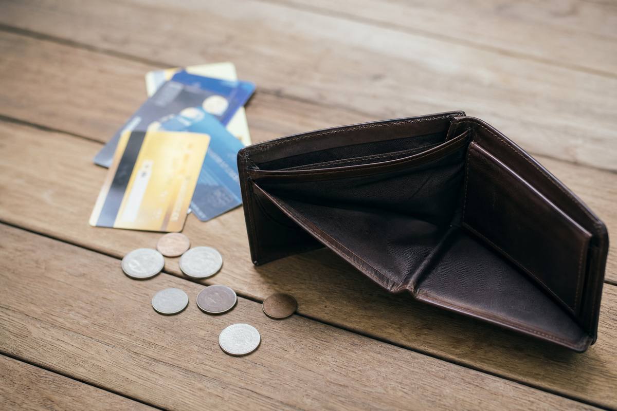 Empty open wallet with scattered credit cards suggesting it has been lost